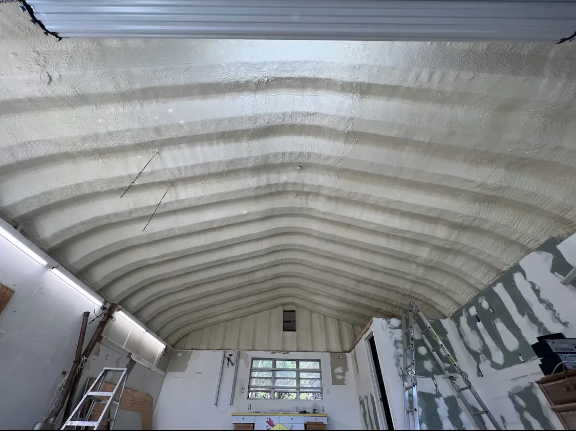 Spray polyurethane foam applied to the underside of a metal roof deck in Maili
